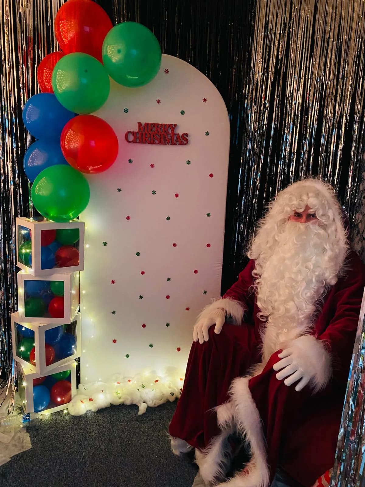 Festive red and green balloon arch for Father Christmas photo zone at Little Sunbeams Preschool Epping