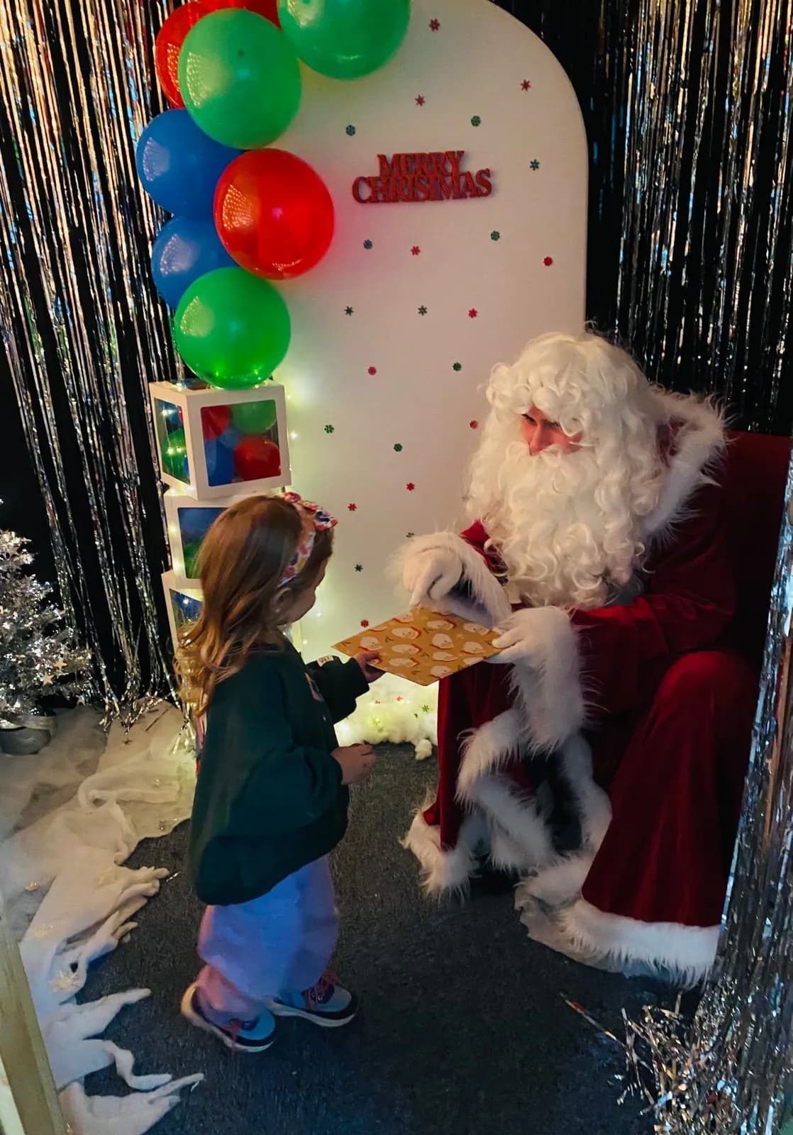 Winter wonderland photo zone with balloon arrangements at Little Sunbeams Preschool Christmas party